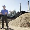 NV Energy project manager David Sims shows some of the 750 tons of waste wood that will be burned wi