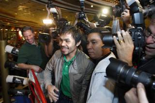 Manny Pacquiao makes his way through fans and media during his grand arrival at the MGM Grand Hotel on Tuesday. Pacquaio will face Miguel Cotto in a WBO welterweight title fight on Nov. 14 at the MGM Grand Garden Arena.