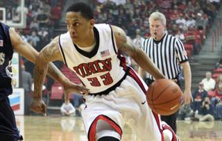 UNLV guard Tre'Von Willis drives in against Washburn during a preseason game Tuesday at the Thomas & Mack Center.
