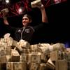 Joe Cada, 21, holds up some of his $8.5 million winnings after beating Darvin Moon in the final round of the 2009 World Series of Poker tournament early Tuesday at the Rio.

