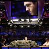 Joe Cada, left, a 21-year-old poker professional from Michigan, competes against Darvin Moon, right,