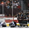 Las Vegas Wranglers goaltender Michael Ouzas and defenseman John Schwarz lay on the ice as Utah Grizzlies players celebrate scoring a second period goal in Utah's 3-2 victory Tuesday night at the Orleans Arena.