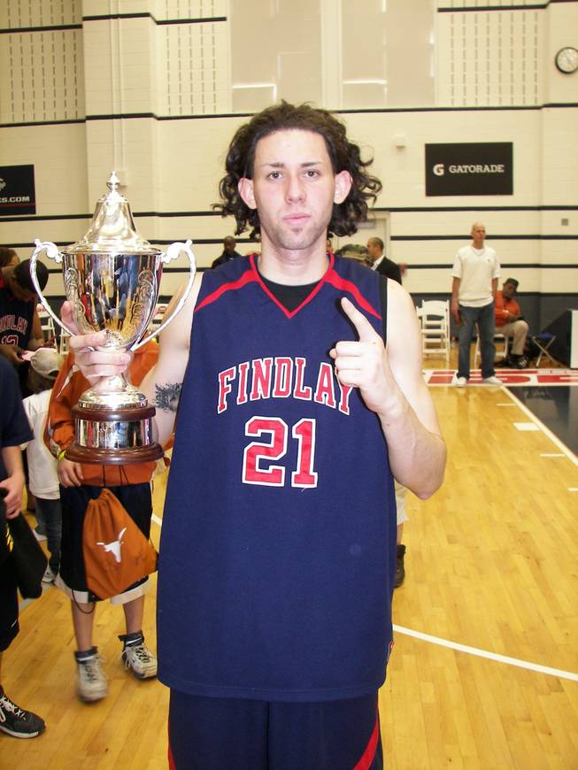 Carlos Lopez holds the championship trophy after the Findlay Prep Pilots defeated Oak Hill Academy, 74-66, in the title game of the inaugural ESPN RISE National High School Invitational in April. Lopez, now with UNLV, is leaning toward redshirting his freshman year.