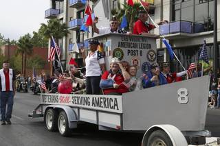 Veterans of the Las Vegas American Legion Post 8 salute to the crowd while riding in their float during the annual Veterans Day parade Wednesday in downtown Las Vegas.