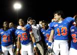 Bishop Gorman football coach Tony Sanchez puts his arms around running backs Victor Belen (left) and Shaquille Powell following the Gaels 38-28 victory Friday in the Sunset Regional semifinals.