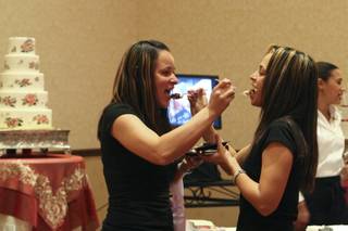 Ari Castellano and Imani Ortiz, who have already received their domestic partnership, plan for their commitment ceremony sampling wedding cake while attending the LGBT Wedding Expo hosted by the Rainbow Wedding Network at the JW Marriott Las Vegas Resort & Spa on Sunday, Nov. 15, 2009.