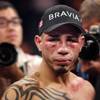 Miguel Cotto remains in the ring following his 12th-round TKO defeat at the hands of Manny Pacquiao 