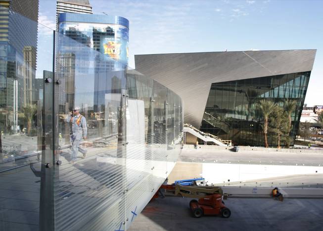 A worker uses a pedestrian bridge from the Crystals retail mall during a tour of MGM Mirage's CityCenter project Wednesday, Nov. 18, 2009. Properties in the $8.5 billion project will open next month. 