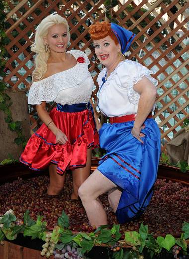 Holly Madison stomps grapes with a Lucille Ball look-alike at the unveiling of Beaujolais Nouveau at the Paris on Nov. 18, 2009.