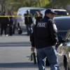 A North Las Vegas police officer walks toward the crime scene as police investigate the death of an 