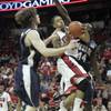 UNLV guard Tre'Von Willis drives past UNR forwards Luke Babbitt, left, and Dario Hunt during the second half of their game Wedensday at the Thomas & Mack Center. UNLV hosts Southern Illinois tonight.