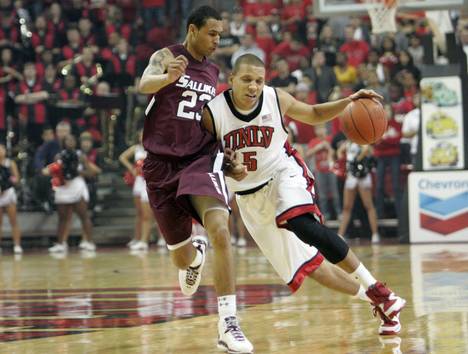 UNLV's Derrick Jasper is covered by Justin Bocot as he takes the ball down the court against Southern Illinois at the Thomas & Mack Center Saturday.