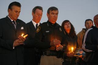Sheriff Doug Gillespie, center, takes part in a vigil for fallen Metro Officer Trevor Nettleton in front of the Metro Police Bolden Area Command Monday, Nov. 23, 2009. Steve Schorr, vice president of public and government affairs for Cox Communications, is at left. Metro corrections Officer Daniel Leach, killed in an accident this weekend, was also honored during the vigil. Members of the Safe Valley United, Safe Village, Homeless Alliance and other faith-based groups organized the vigil. 