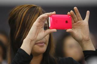 A student records video of lunchtime entertainment with her iPhone during the Sun Youth Forum at the Las Vegas Convention Center Tuesday, Nov. 24, 2009.