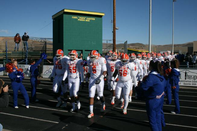 Xavier Grimble, No. 6, leads Bishop Gorman on to the field Saturday in Sparks to take on Reed. Despite not catching a pass, Grimble helped Gorman topple Reed 62-21.