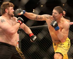 Brendan Schaub misses a right hand on Roy Nelson during the main event of the Ultimate Fighter Championship Saturday night at the Palms.   Nelson won the fight and the six-figure contract with the UFC.