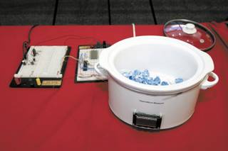 By rigging a microcontroller to an ordinary slow-cooker, Rapheal Hicks and Vincent Poteat were able to increase and decrease the temperature and liquefy the chocolate. Hicks and Poteat call it their 