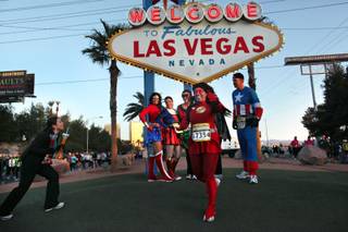 Runners dressed as super heroes stop for photos during the Rock 'n' Roll Las Vegas Marathon on Sunday, Dec. 6, 2009. 