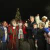 Henderson Mayor Andy Hafen (right of center) celebrates with Santa Claus and guests after lighting the Christmas tree Friday night at the 2009 WinterFest celebration at the Henderson Events Plaza.