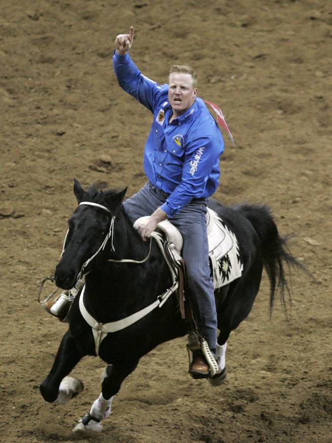 Lee Graves celebrates after winning the gold buckle for steer wrestling at the 2009 National Finals Rodeo Saturday, Dec. 12, 2009, at the Thomas & Mack.