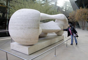Lily Chen, a tourist from Taiwan, touches "Reclining Connected Forms," a Henry Moore sculpture at CityCenter Tuesday, December 15, 2009.  