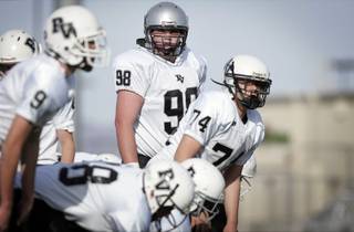 Eighth grader Zack Singer, center, of the Palo Verde Panthers Desert Youth Football League team plays in a game against the Canyon Springs Southern Nevada Middle School League team at Valley High School in Las Vegas Saturday, December 19, 2009. 