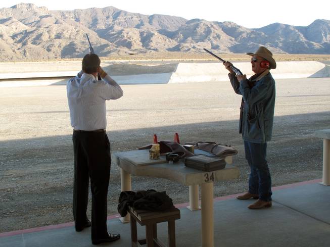 Firing the first shots, Nevada state Sen. John Lee, left, and Clark County Commissioner Tom Collins officially open the new Clark County Shooting Park Saturday morning.