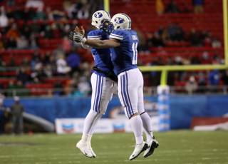 Max Hall (left) and Manase Tonga celebrate after a BYU touchdown during the MAACO Bowl Las Vegas Tuesday at Sam Boyd Stadium.  BYU dominated Oregon St. with a 44-20 win.