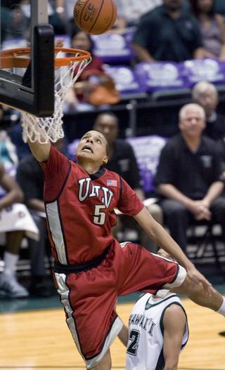 UNLV guard Derrick Jasper (5) scores two points on this layup as Hawaii guard Hiram Thompson (2) trails on the play in the first half Wednesday Dec. 23, 2009, at the Diamond Head Classic in Honolulu.