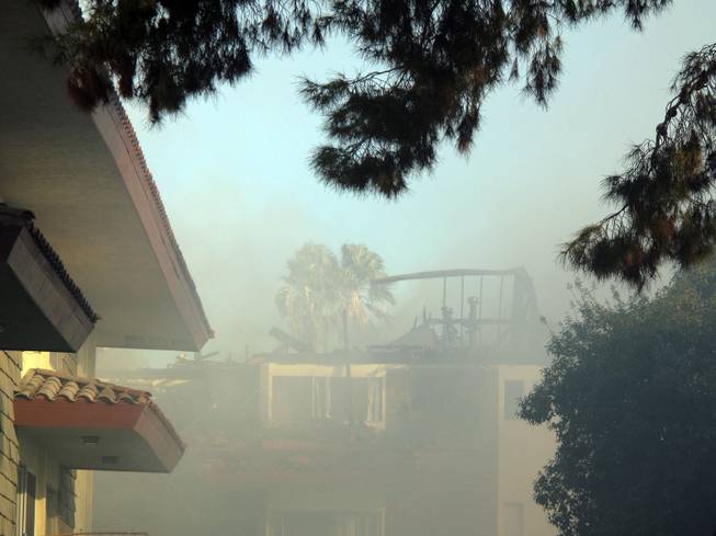Smoke covers an apartment complex and the surrounding neighborhood on Wednesday morning.