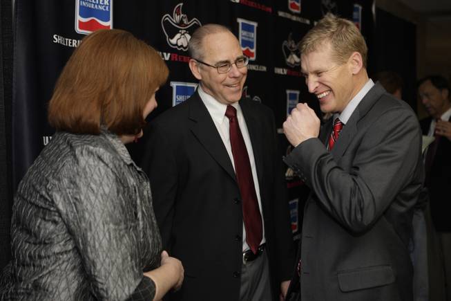 New UNLV head football coach Bobby Hauck, right,  chats with UNLV President Neal Smatresk and Smatresk's wife Debbie during a news conference at UNLV Wednesday, December 23, 2009. Hauck had a 80-17 record at Montana where he was the head coach from 2003.