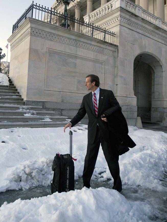 Sen. John Thune, R-S.D, waits for his ride in the snow outside of the Capitol in Washington, Thursday, Dec. 24, 2009, after the Senate passed the health care reform bill.