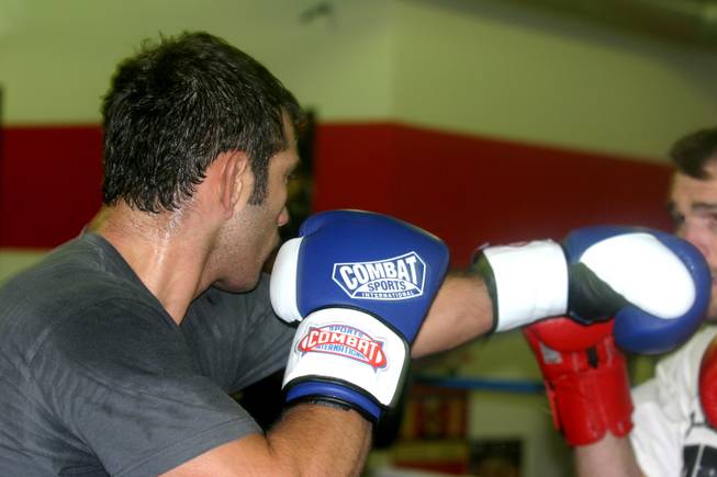 John Gunderson lands a blow to the face of sparring partner George Roop during practice at LA Boxing. 