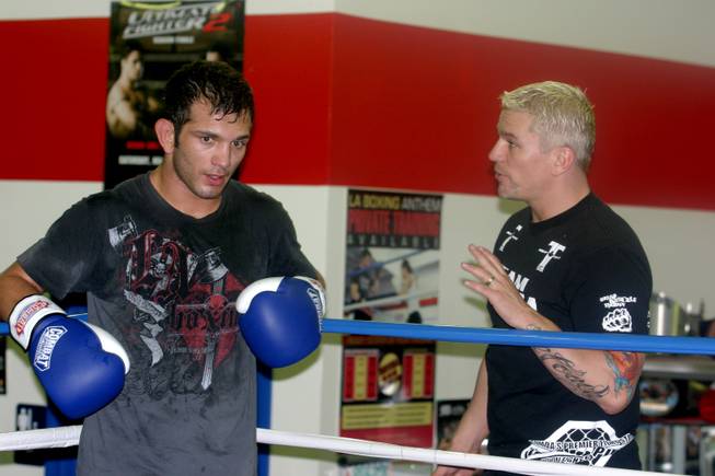 John Gunderson (left) gets some advice from his coach Shawn Tompkins during practice at LA Boxing. Gunderson will take on Rafaello Oliveira at UFC 108. 