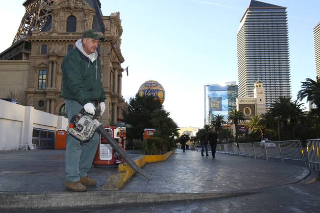 Bally's employee Craig Mackelprang cleans the sidewalks on New Year's Day 2010 following the New Year's Eve celebration on the Las Vegas Strip.