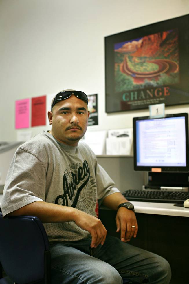 Applying for unemployment for the first time in his life, Julian Gomez, who has two children and a third on the way, uses a computer to fill out the application Thursday at Nevada JobConnect in North Las Vegas. 
