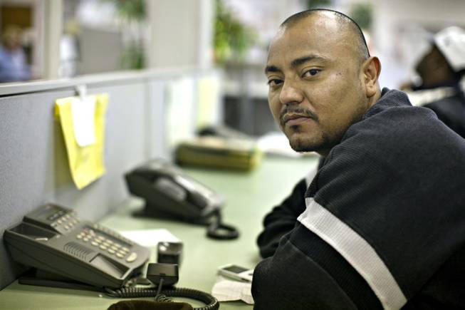 Nelson Garcia, who worked at Imperial Palace but now is just on call to work there, borrows a phone to call the unemployment office.