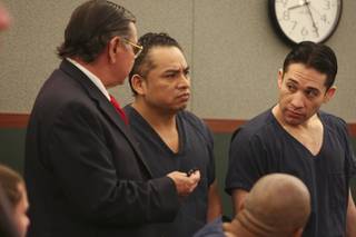 Porfirio Duarte-Herrara, right, and Omar Rueda-Denvers, center, listen to a court interpreter as District Court Judge Michael P. Villani sentences Rueda-Denvers to life without parole Thursday at the Regional Justice Center.  Rueda-Denvers was sentenced to life without parole and Duarte-Herrera will be sentenced Jan. 28 for killing Willebaldo Dorantes Antonio after placing a pipe bomb on his truck at the Luxor parking garage in May 2007.
