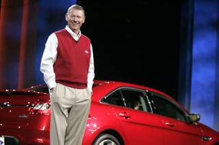 Ford CEO Alan Mulally speaks during the keynote address with a 2010 Ford Taurus behind him during the Consumer Electronics Show at the Hilton Center in Las Vegas Thursday, January 7, 2010.
