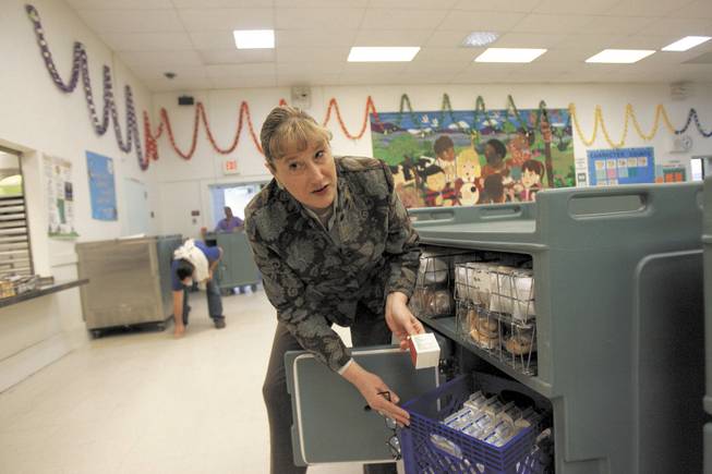 Fay Herron Elementary School Principal Kelly Sturdy shows breakfast items to be delivered to classrooms.