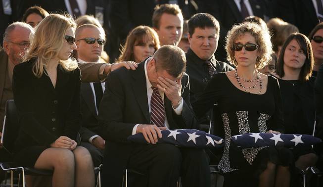 Richard Bentley Cooper, center, the son of Stanley Cooper, cries after receiving a flag during the funeral services the slain court security officer Stanley Cooper outside of Central Christian Church in Henderson Monday, January 11, 2010.