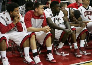 UNLV players, from left, Steve Jones, Mychal Martinez, Brice Massamba and Matt Shaw react during the closing seconds of Saturday's game against Utah. UNLV lost the game 73-69.