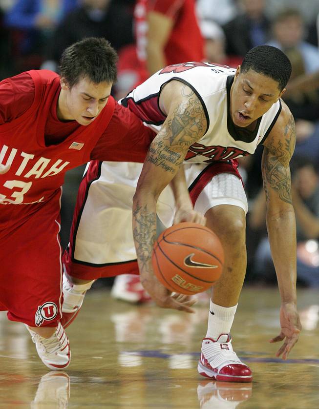 UNLV guard Tre'Von Willis and Utah guard Marshall Henderson chase down a loose ball during the second half of a Jan. 16 Mountain West Conference game. Utah won the game, 73-69.