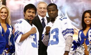 Manny Pacquiao and Joshua Clottey join Dallas Cowboys owner Jerry Jones on-stage during a press conference at Dallas Cowboys Stadium in Arlington, Texas on Jan. 19, 2010. The two welterweights are scheduled to meet on March 13 at Dallas Cowboys Stadium.