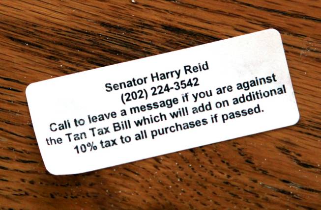 In response to the tanning tax, Palm Beach Tan is providing customers with contact information for Sen. Harry Reid.