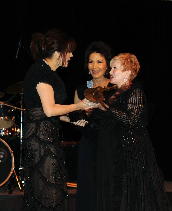 Marie Osmond accepts her NBT Woman of the Year honor from NBT co-chairs Nancy Houssels, far right, and Wendy Plaster.