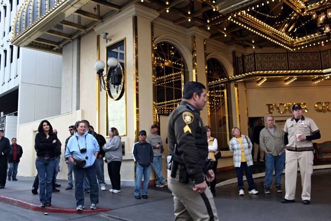A crowd gathers at the Four Queens valet entrance near the scene of a fatal crash at the Fremont Street Experience in downtown Las Vegas on Tuesday, Jan. 26, 2010. 