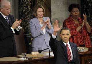 President Barack Obama waves after delivering his State of the Union address on Capitol Hill in Washington on Wednesday, Jan. 27, 2010. Vice President Joe Biden and House Speaker Nancy Pelosi applaud.