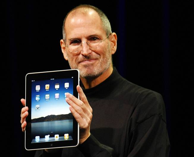 Apple CEO Steve Jobs shows off the new iPad during an event in San Francisco, Wednesday, Jan. 27, 2010.