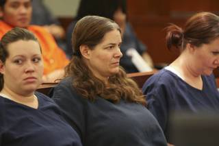 Melanie Ochs, center, sits in court waiting for her sentencing hearing to begin before District Court Judge Michael P. Villani on Jan. 28 at the Regional Justice Center. Sentencing was delayed until Feb. 4